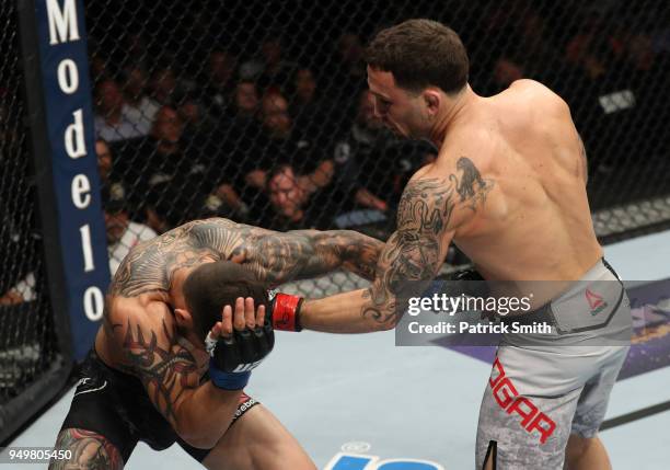 Frankie Edgar punches Cub Swanson in their featherweight fight during the UFC Fight Night event at the Boardwalk Hall on April 21, 2018 in Atlantic...