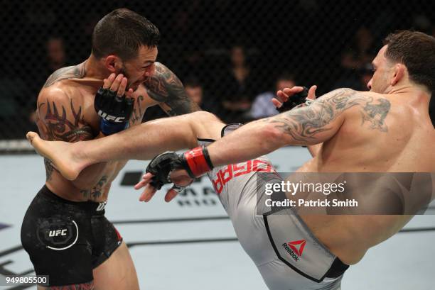 Frankie Edgar kicks Cub Swanson in their featherweight fight during the UFC Fight Night event at the Boardwalk Hall on April 21, 2018 in Atlantic...