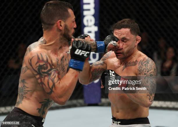 Cub Swanson punches Frankie Edgar in their featherweight fight during the UFC Fight Night event at the Boardwalk Hall on April 21, 2018 in Atlantic...