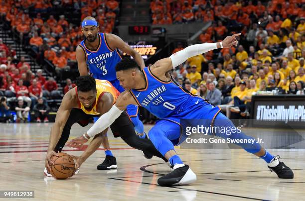 Russell Westbrook of the Oklahoma City Thunder and Donovan Mitchell of the Utah Jazz go for the ball in the second half during Game Three of Round...