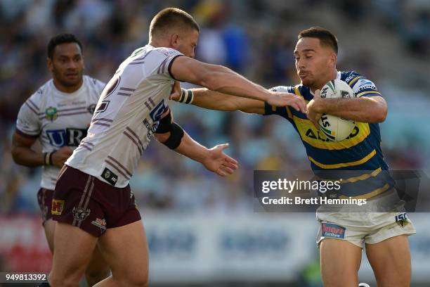 Corey Norman of the Eels is tackled during the round seven NRL match between the Parramatta Eels and the Manly Sea Eagles at ANZ Stadium on April 22,...