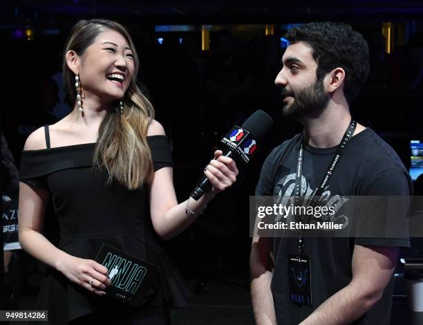 Esports host Sue Lee interviews gamer Maurilio "Blind" Gramajo of California after he won his second straight match of "Fortnite" while playing...