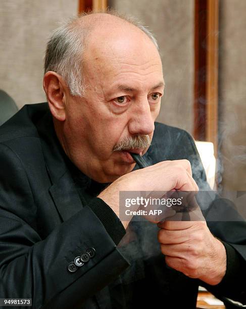 This picture taken on Decmber 10, 2009 shows Zurab Mikvabia, the director of the Institute of Experimental Pathology and Therapy lighting his pipe in...