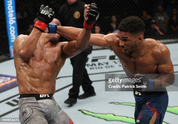Kevin Lee punches Edson Barboza of Brazil in their lightweight fight during the UFC Fight Night event at the Boardwalk Hall on April 21, 2018 in...