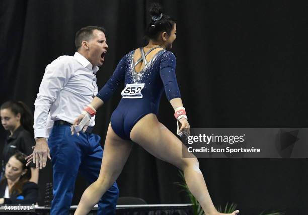 Assistant coach Chris Waller is excited by Anna Glenn's performance on the bars during the NCAA Women's Gymnastics National Championship championship...