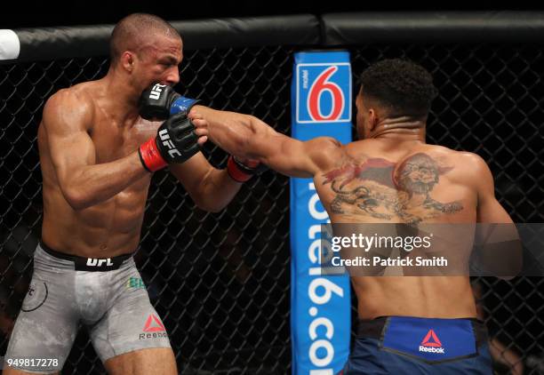 Kevin Lee punches Edson Barboza of Brazil in their lightweight fight during the UFC Fight Night event at the Boardwalk Hall on April 21, 2018 in...