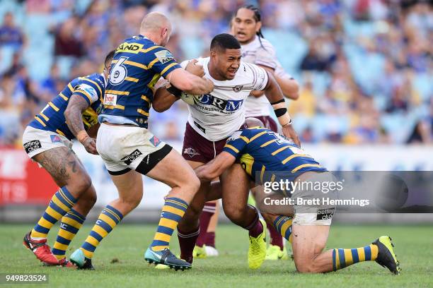 Taniela Paseka of Manly is tackled during the round seven NRL match between the Parramatta Eels and the Manly Sea Eagles at ANZ Stadium on April 22,...