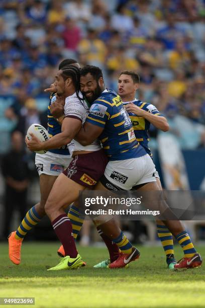 Martin Taupau of Manly is tackled during the round seven NRL match between the Parramatta Eels and the Manly Sea Eagles at ANZ Stadium on April 22,...