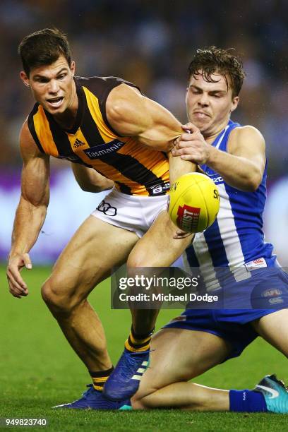 Cameron Zurhaar of the Kangaroos tackled Jaeger O'Meara of the Hawks during the round five AFL match between the North Melbourne Kangaroos and the...