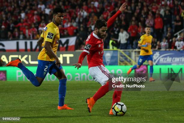 Benfica's midfielder Rafa Silvashoots in front of Estoril's defender Ailton to score a goal during the Portuguese League football match between...