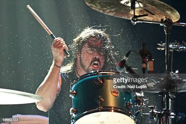 Dave Grohl of Them Crooked Vultures performs on stage playing drums at Hammersmith Apollo on December 17, 2009 in London, England.