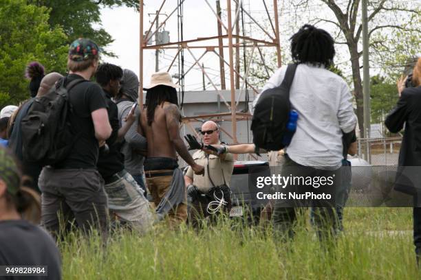 Police confront protesters standing on train tracks during a National Socialist Movement rally at Greenville Street Park in Newnan, Georgia, USA on...