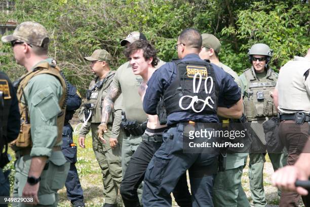 Protester is arrested during a National Socialist Movement rally at Greenville Street Park in Newnan, Georgia, USA on April 21, 2018.