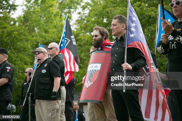 Neo-Nazis hold signs and flags during a National Socialist Movement rally at Greenville Street Park in Newnan, Georgia, USA on April 21, 2018.