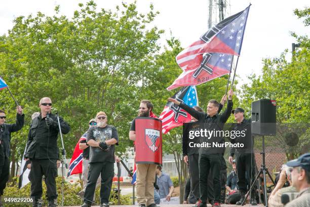 Neo-Nazi salutes a speaker during a National Socialist Movement rally at Greenville Street Park in Newnan, Georgia, USA on April 21, 2018.
