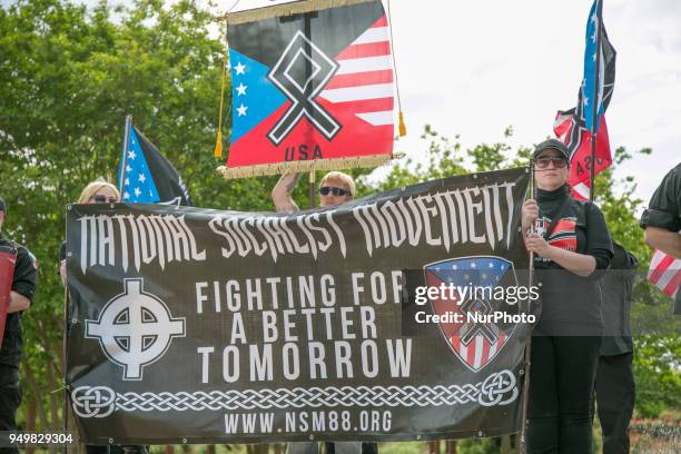 Neo-Nazis hold a banner during a National Socialist Movement rally at Greenville Street Park in Newnan, Georgia, USA on April 21, 2018.