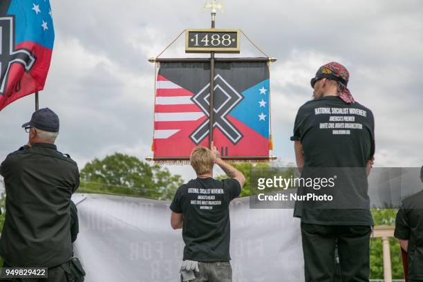 Neo-Nazi holds a sign during a National Socialist Movement rally at Greenville Street Park in Newnan, Georgia, USA on April 21, 2018.