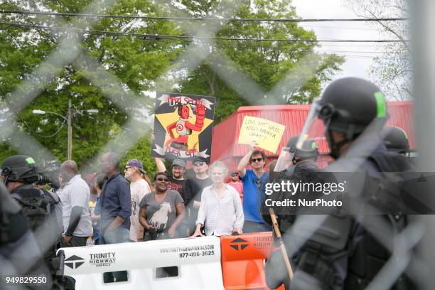 Protesters hold signs during a National Socialist Movement rally at Greenville Street Park in Newnan, Georgia, USA on April 21, 2018.
