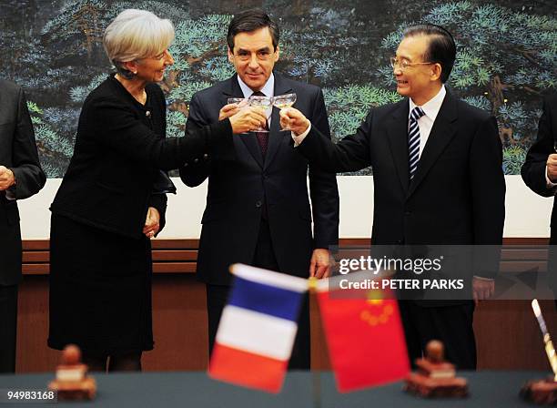 China's Prime Minister Wen Jiabao toasts with his French counterpart Francois Fillon and French Finance Minister Christine Lagarde during a signing...