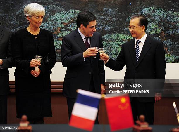 China's Prime Minister Wen Jiabao toasts with his French counterpart Francois Fillon as French Finance Minister Christine Lagarde looks on during a...