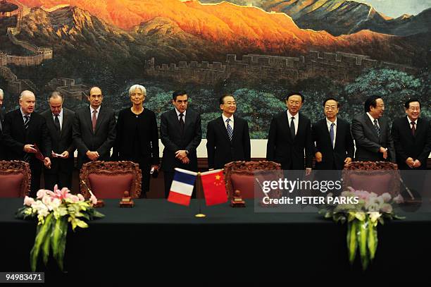 China's Prime Minister Wen Jiabao stands with his French counterpart Francois Fillon , French Finance Minister Christine Lagarde and other ministers...