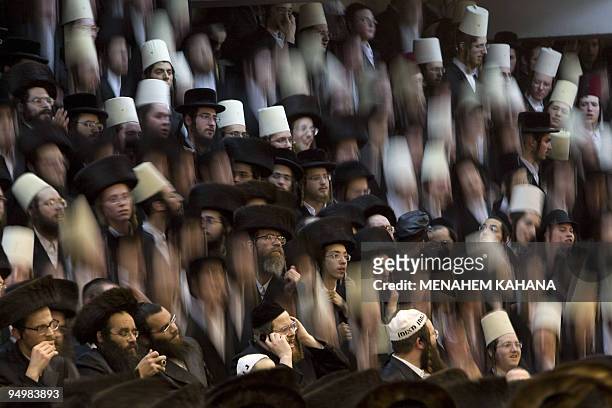 Ultra-Orthodox Jews belonging to the Vishnitz Hassidic sect dance on their benches as they celebrate the Jewish festival of Purim late on March 9,...