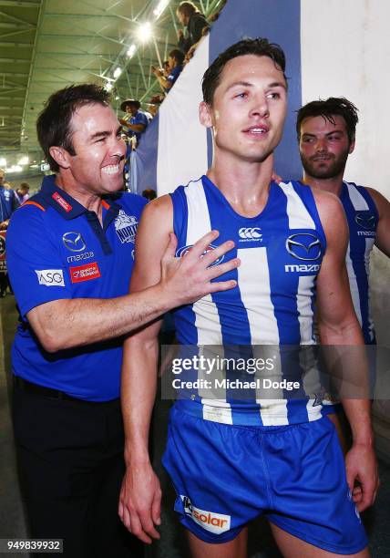 Kangaroos head coach Brad Scott hugs Ben Jacobs of the Kangaroos after their win during the round five AFL match between the North Melbourne...