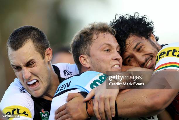 Matt Moylan of the Sharks is tackled by Isaah Yeo and Corey Harawira-Naera of the Panthers during the round seven NRL match between the Cronulla...