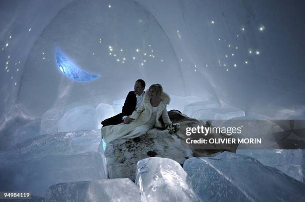 Couple pose for pictures after being married at the chapel of the ice hotel in Jukkasjaervi on January 9, 2009. Around 150 marriages happen at the...