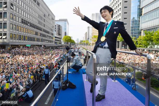 Two-time Olympic figure skating men's singles gold medallist Yuzuru Hanyu waves during his victory parade in his home town of Sendai city on April...