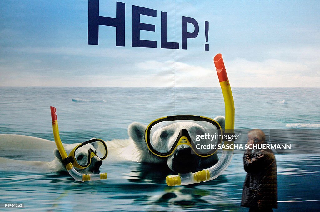 A fairgoer walks past a poster featuring