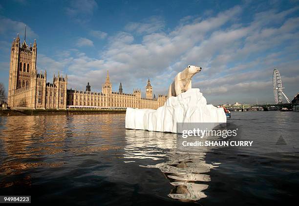 Life-like 16ft high sculpture of an iceberg featuring a stranded polar bear and its cub is pictured on the River Thames in London on January 26,...