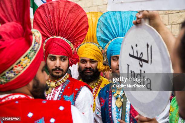 Artists perform with percussion instruments as they march at the opening ceremony of the 6th International Festival for Drums and Traditional Arts in...