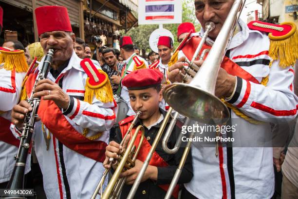 Artists perform with percussion instruments as they march at the opening ceremony of the 6th International Festival for Drums and Traditional Arts in...