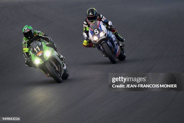 French rider Alan Techer on his Honda CBR 1000 N°5 exceeds French rider Randy de Puniet on his Kawasaki Formula EWC N°11 during the 41st Le Mans...