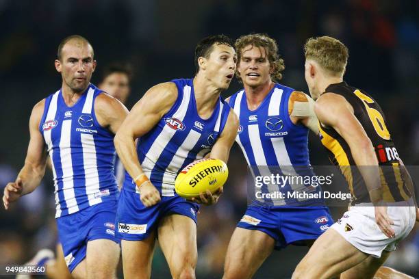 Ben Jacobs of the Kangaroos handballs during the round five AFL match between the North Melbourne Kangaroos and the Hawthorn Hawks at Etihad Stadium...