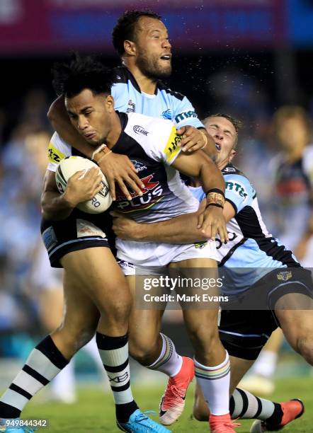 Christian Crichton of the Panthers is tackled by Joseph Paulo of the Sharks during the round seven NRL match between the Cronulla Sharks and the...