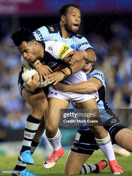 Christian Crichton of the Panthers is tackled by Joseph Paulo of the Sharks during the round seven NRL match between the Cronulla Sharks and the...