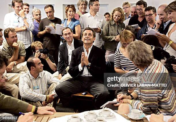 French Interior minister and president of French right-wing party UMP Nicolas Sarkozy speaks to French journalists Helene Jouan , Jean-Francois...