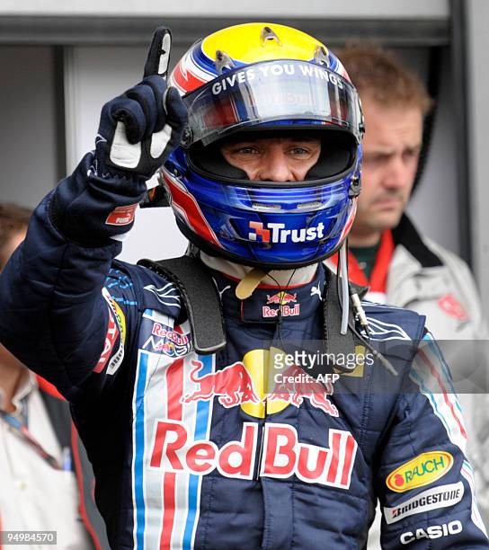 Red Bull's Australian driver Mark Webber celebrates in the parc ferme of Nurburgring racetrack on July 11, 2009 in Nurburg, after the qualifying...