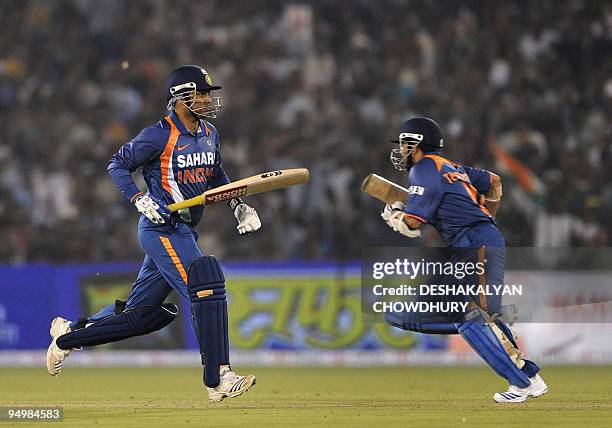 Indian cricketers Virender Sehwag and Sachin Tendulkar run between wickets during the third One-Day International at the Barabati Stadium in Cuttack...