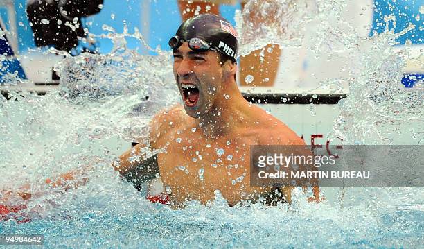 Swimmer Michael Phelps reacts after winning the men's 100m butterfly swimming final at the National Aquatics Center during the 2008 Beijing Olympic...