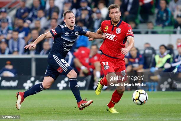 Leigh Broxham of Melbourne Victory and Johan Absalonsen of Adelaide United fight for the ball during the A-League Elimination Final match between...