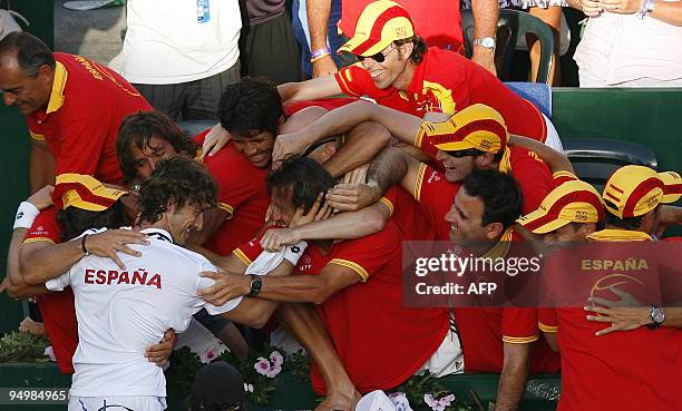 Spanish Juan Carlos Ferrero celebrates with teammates after winning the fifth Davis Cup match Spain vs Germany against Germany's Andreas Beck at the...