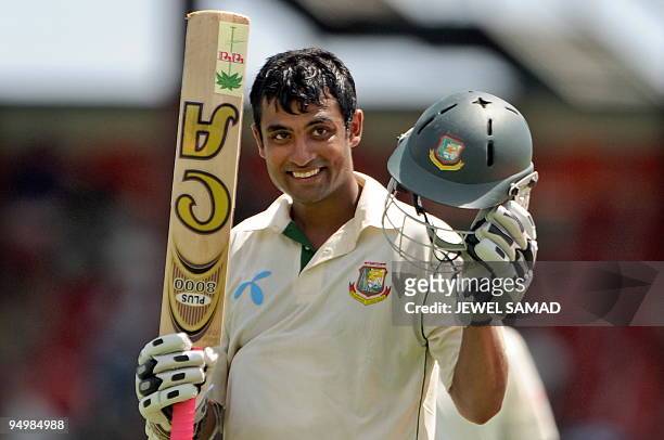 Bangladeshi cricketer Tamim Iqbal celebrates after compeleting a century during the fourth day of the first Test match between West Indies and...