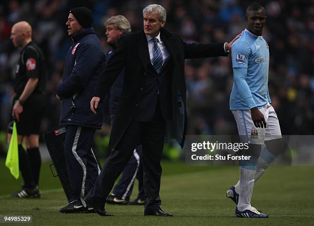 Manchester City manager Mark Hughes consoles Micah Richards as he is substituted during the Barclays Premier League game between Manchester City and...