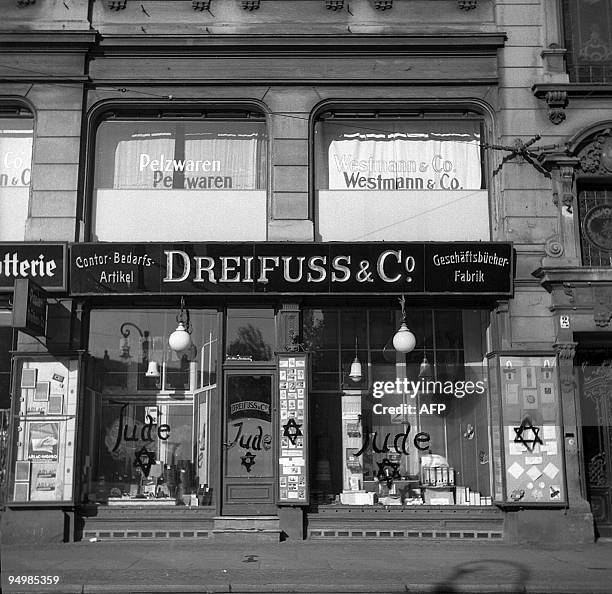 Picture dated 10 November 1938 in Germany showing a Jewish-run shop after being vandalized by Nazis and inscripted with antisemitic graffitis....