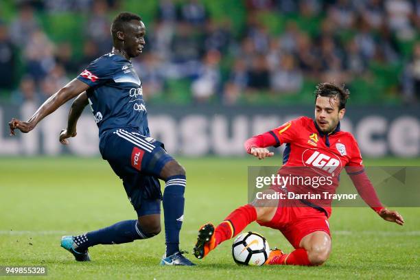 Thomas Deng of the Victory and Nikola Mileusnic of Adelaide United compete during the A-League Elimination Final match between Melbourne Victory and...