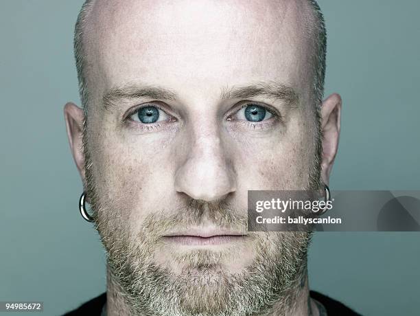 young man with beard, portrait. - earrings stock pictures, royalty-free photos & images