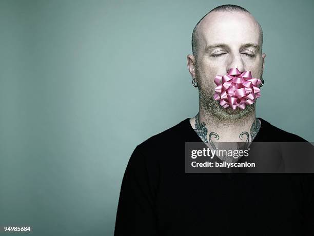 man with pink ribbon in mouth. - ribbon in mouth stock pictures, royalty-free photos & images